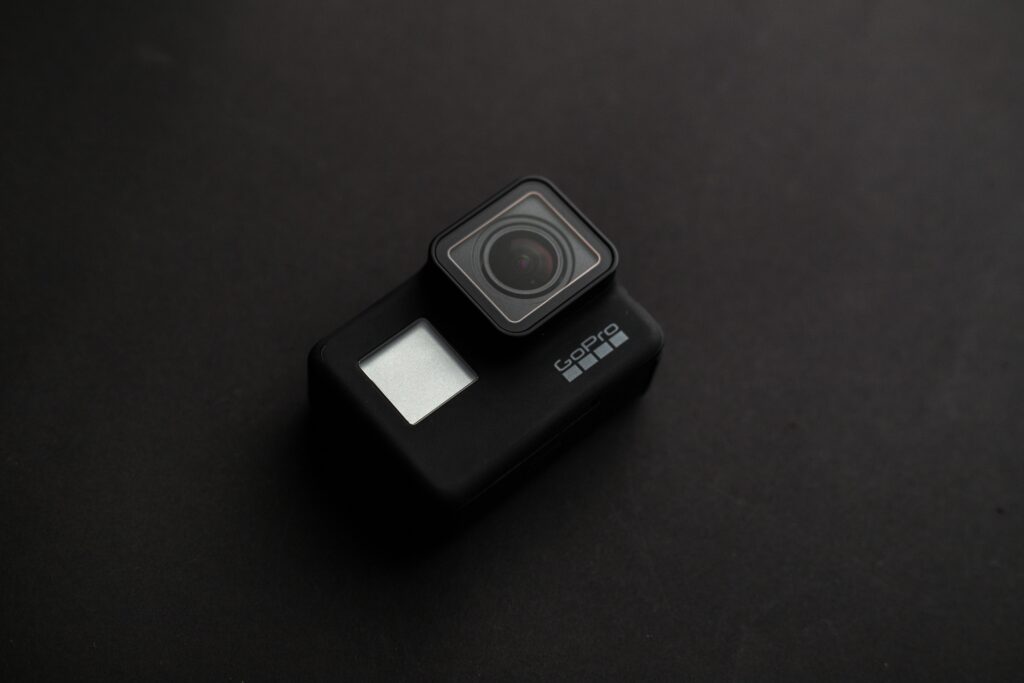 High-quality image of a GoPro camera on a dark surface, ideal for tech content.